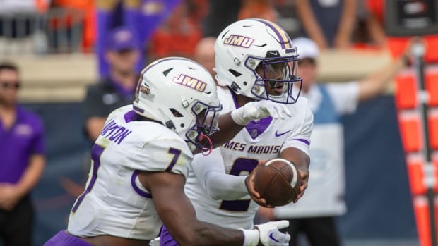 James Madison quarterback Jordan McCloud hands the ball off to running back Ty Son Lawton during the Dukes' 36-35 win over Virginia on Sept. 9, 2023.